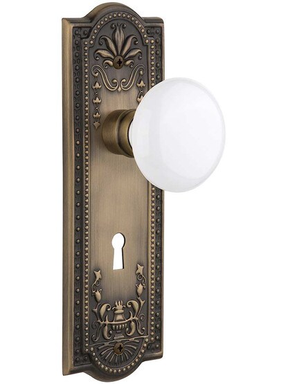 Meadows Door Set with White Porcelain Knobs and Keyhole Single Dummy in Antique Brass.